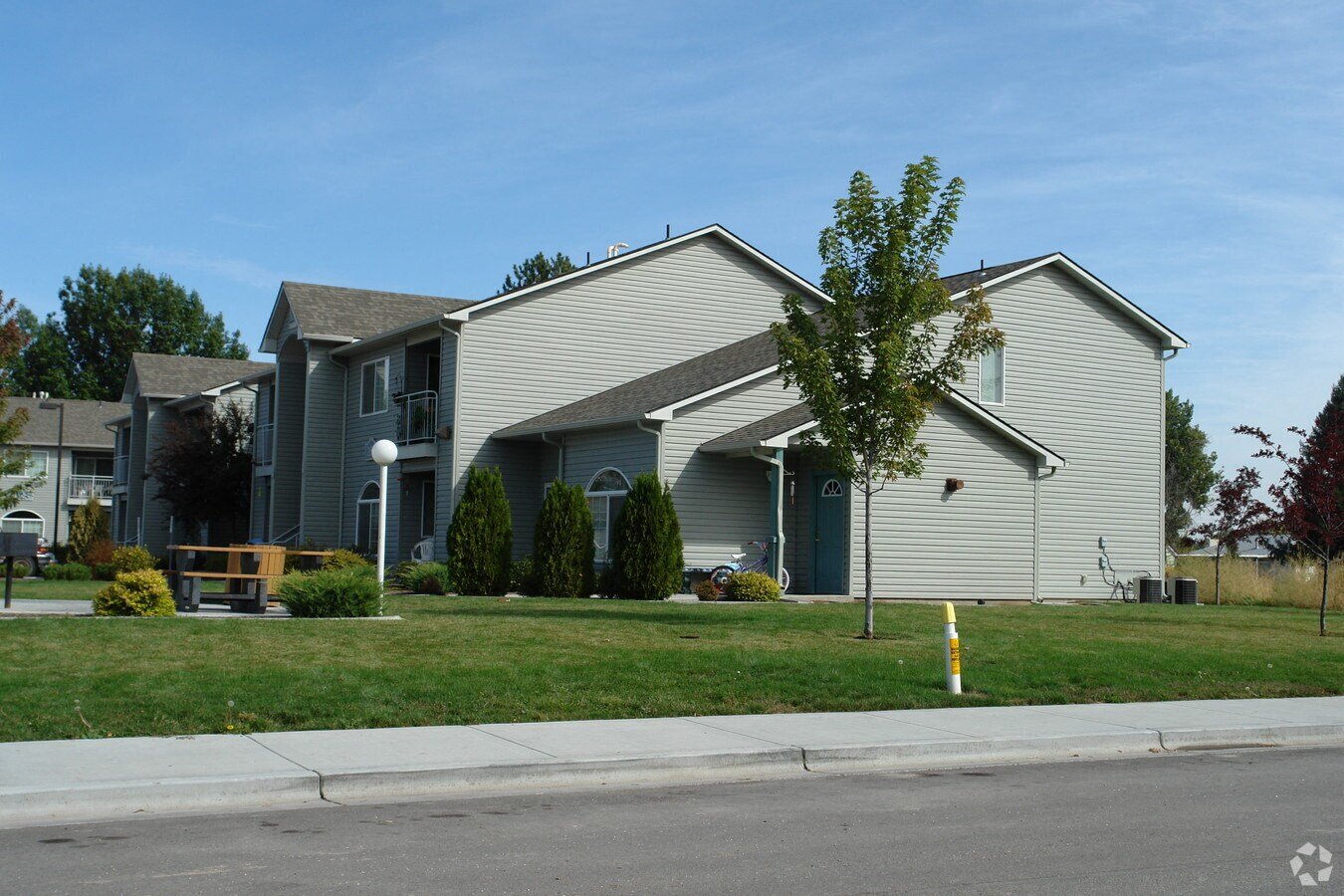 a gray house with a tree in front of it